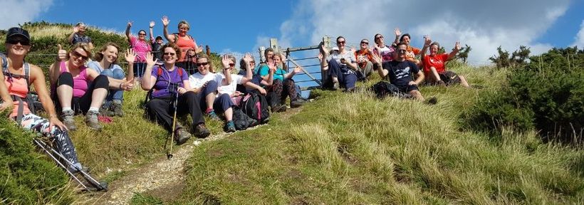 Group sitting together on a trail.